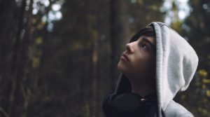 teenager by himself, with headphones