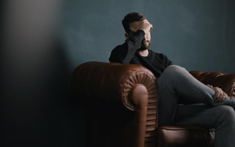 depressed man thinking on sofa